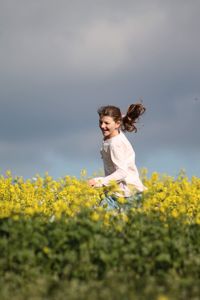 Full length of girl on field against sky