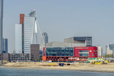 Buildings in city against clear sky