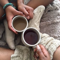 Close-up of two people drinking beverages