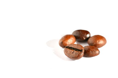 Close-up of coffee beans against white background