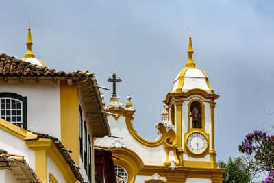 Facade of historic colonial style house and church in the famous city of tiradentes