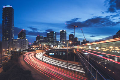 Light trails on road along buildings at night