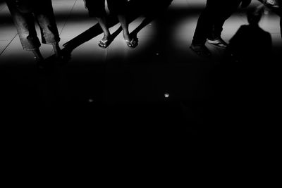 Low section of woman standing on tiled floor