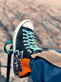 Low section of man wearing canvas shoes