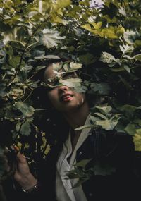 Young woman standing amidst plants