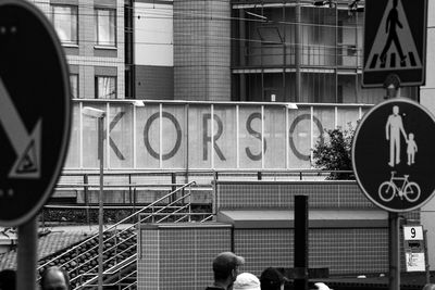 Road sign against building in city