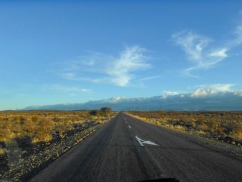 Road passing through landscape against sky