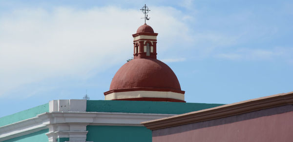 High section of built structure against blue sky