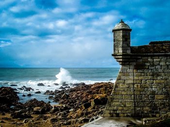 Scenic view of sea against cloudy sky