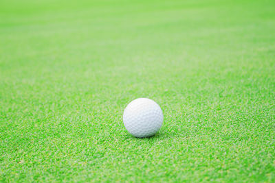 Close-up of golf ball on grass