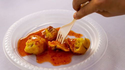 High angle view of person preparing food in plate