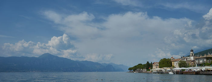 Panoramic view of sea and buildings against sky