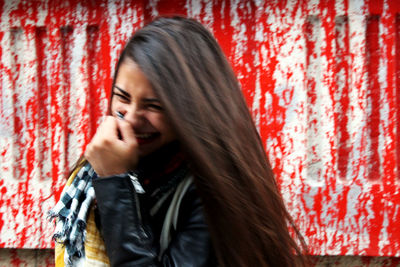 Beautiful woman against red wall