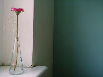 Close-up of flower vase against wall