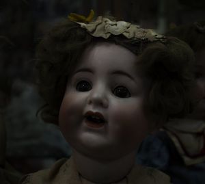 Close-up of cute doll against wall