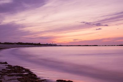 Scenic view of sea against romantic sky at sunset