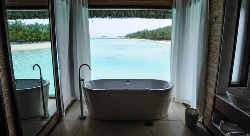 View of bathroom window overlooking sea