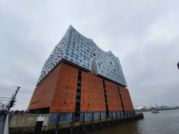 Low angle view of building against cloudy sky