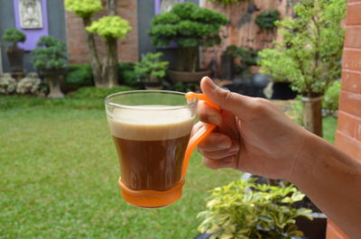 Close-up of hand holding coffee espresso