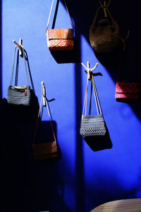 Close-up of clothes hanging against blue wall