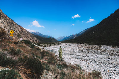 Scenic view of mountains against blue sky