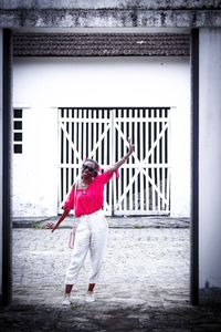 Portrait of man standing against building