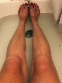 Low section of woman legs in water