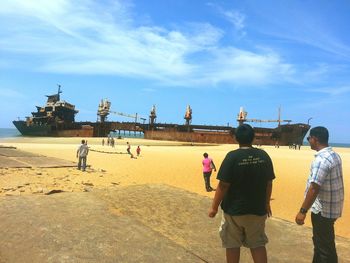 Silhouette of people against cloudy sky