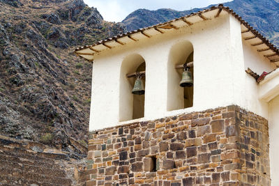 Old church by mountains at ollantaytambo