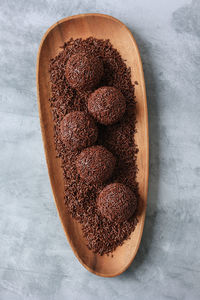 Brigadeiro or brigadier, traditional brazilian sweet dessert. chocolate candy on wooden plate 