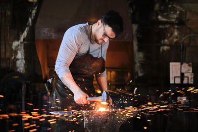 Man working in illuminated room