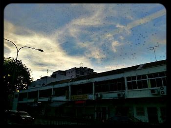 Buildings against cloudy sky
