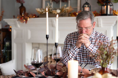 Portrait of senior man using mobile phone at home