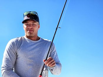 Low angle view of man standing against sky