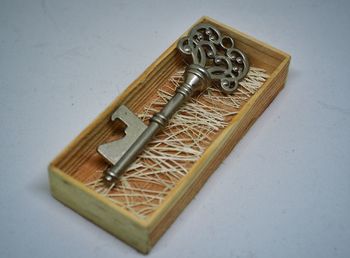 Close-up of key in wooden box on table