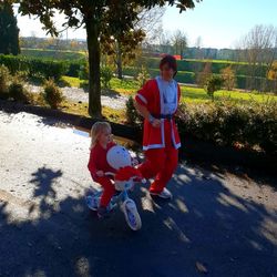 Full length of siblings riding in park