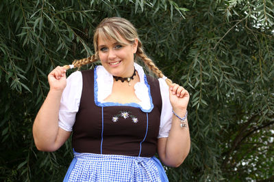 Portrait of smiling young woman standing outdoors