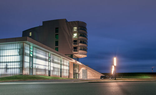 Low angle view of illuminated buildings against sky at dusk