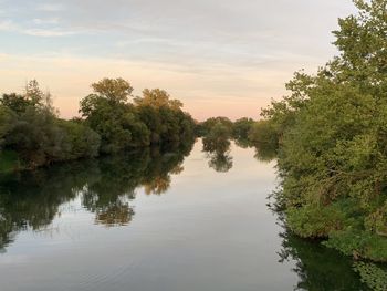 Scenic view of lake against sky at sunset