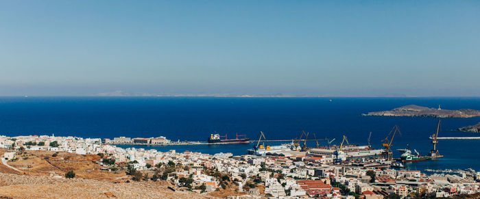 High angle view of townscape by sea against sky