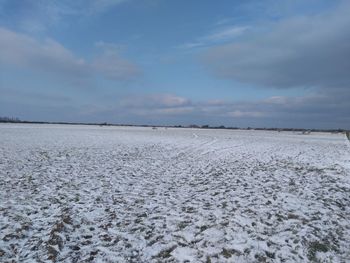 Scenic view of snow covered landscape against sky