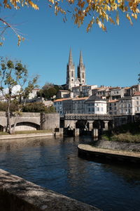 View of building by river against sky