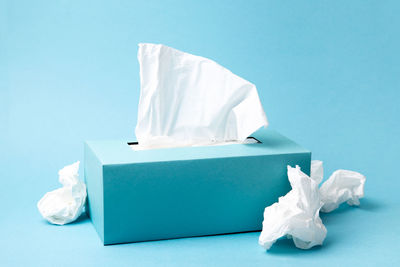 Close-up of white garbage on blue table