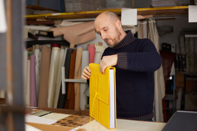 Man reading book at table