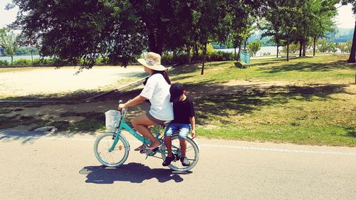 Full length of man riding bicycle on road