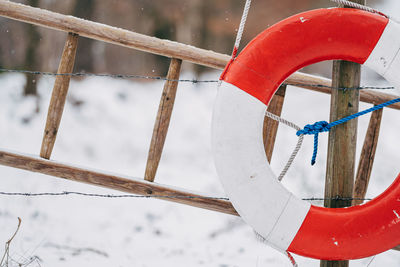 Lifebelt and ladder in front of snowy landscape