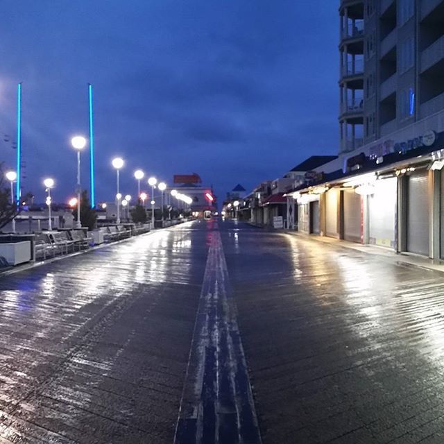 the way forward, street light, sky, diminishing perspective, built structure, architecture, illuminated, building exterior, vanishing point, transportation, lighting equipment, city, empty, railing, incidental people, dusk, railroad track, cloud - sky, outdoors, street