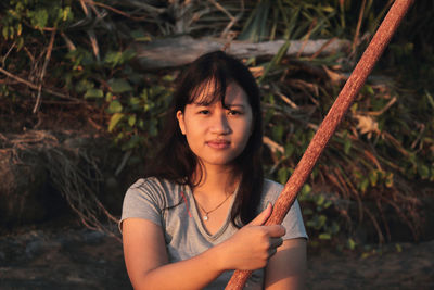 Portrait of happy girl holding plant