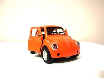 Red toy car against white background