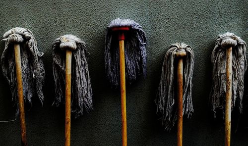 Close-up of mops against wall